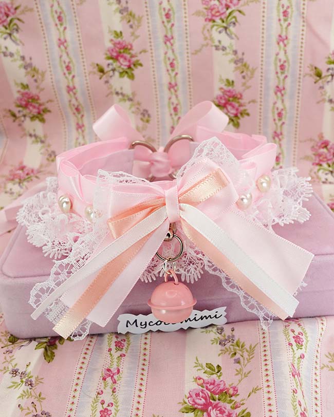 Baby pink kitten play collar with a white lace bow and a pearl heart charm