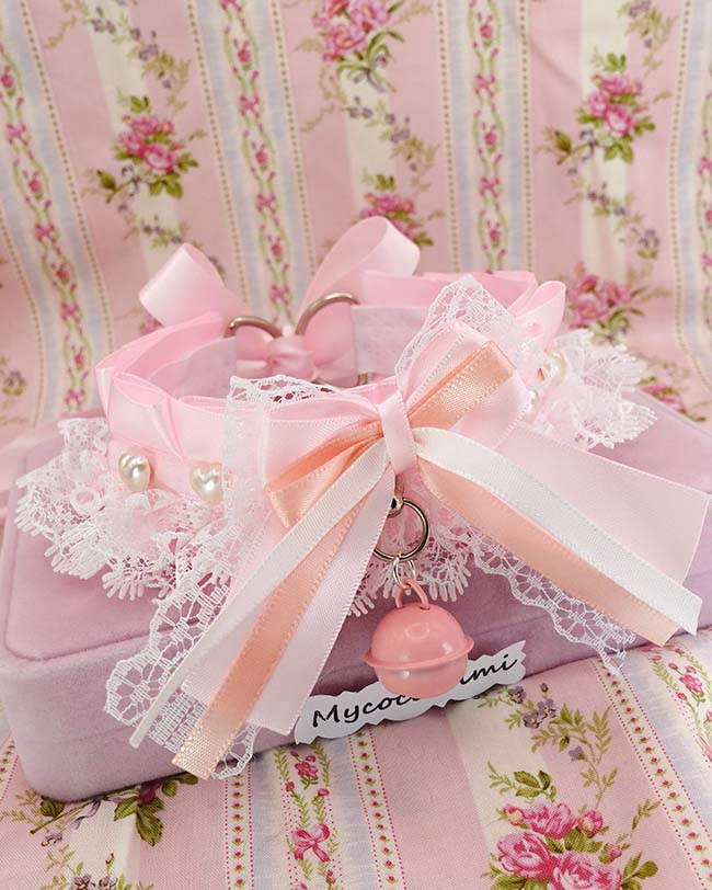 Baby pink kitten play collar with a white lace bow and a pearl heart charm