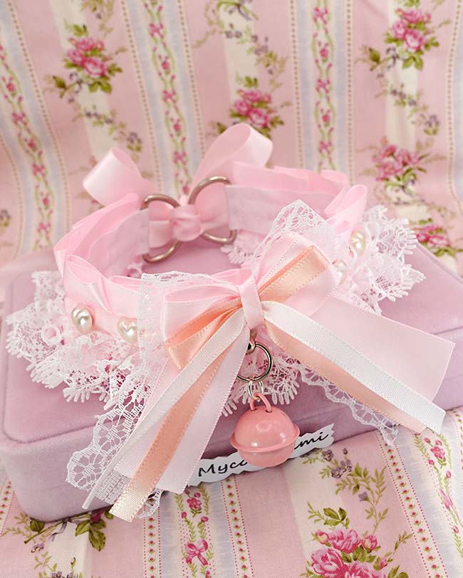 Baby pink kitten play collar with a white lace bow and a pearl heart charm